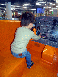 Max in the cockpit of the KLM airplane playground at the Departures Hall of Schiphol Airport