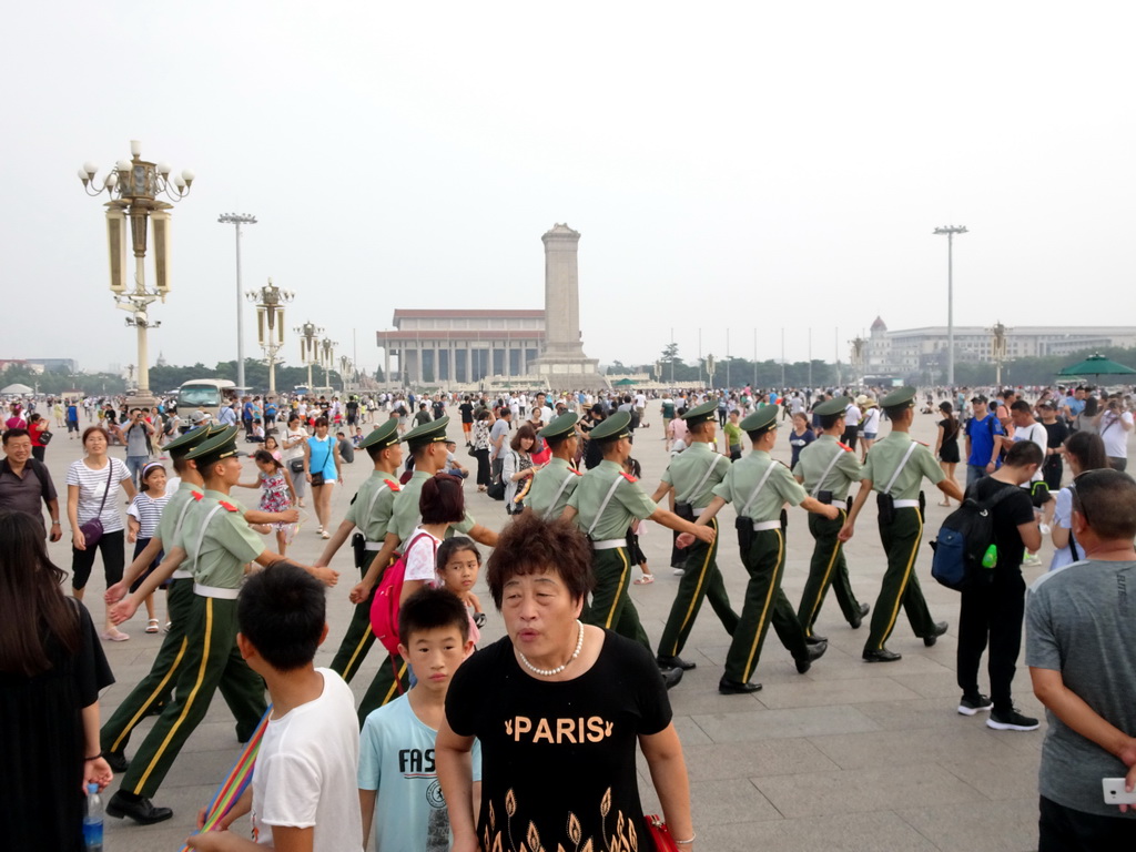 Guards in front of the Mausoleum of Mao Zedong, the Monument to the People`s Heroes and the China Numismatic Museum at Tiananmen Square, before the Flag-Lowering Ceremony