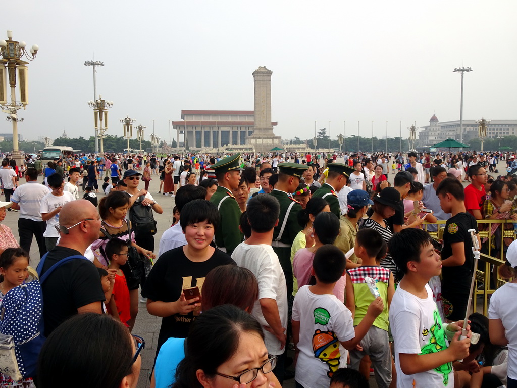 Guards in front of the Mausoleum of Mao Zedong, the Monument to the People`s Heroes and the China Numismatic Museum at Tiananmen Square, before the Flag-Lowering Ceremony