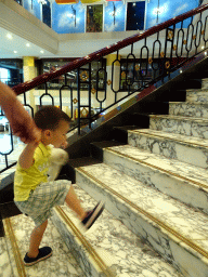 Max on the staircase in the lobby of the Beijing Prime Hotel Wanfujing