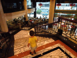 Max at the staircase in the lobby of the Beijing Prime Hotel Wanfujing