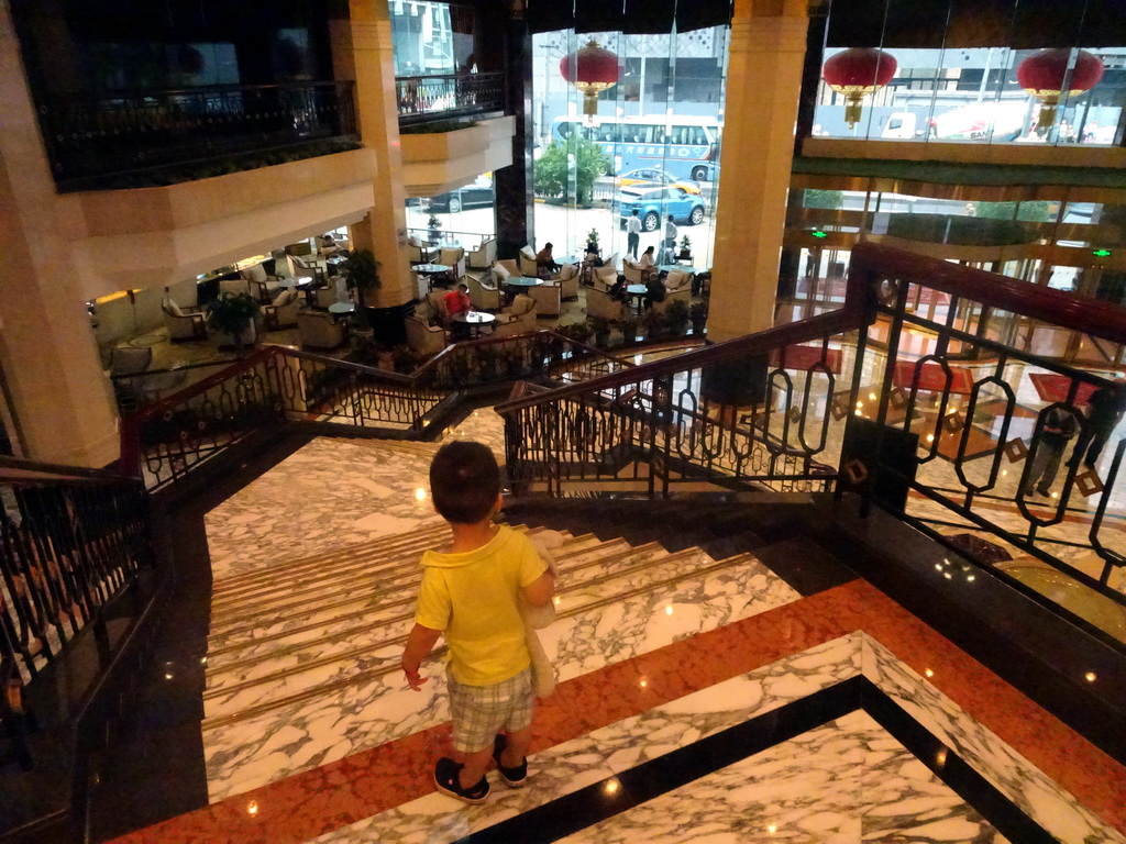 Max at the staircase in the lobby of the Beijing Prime Hotel Wanfujing