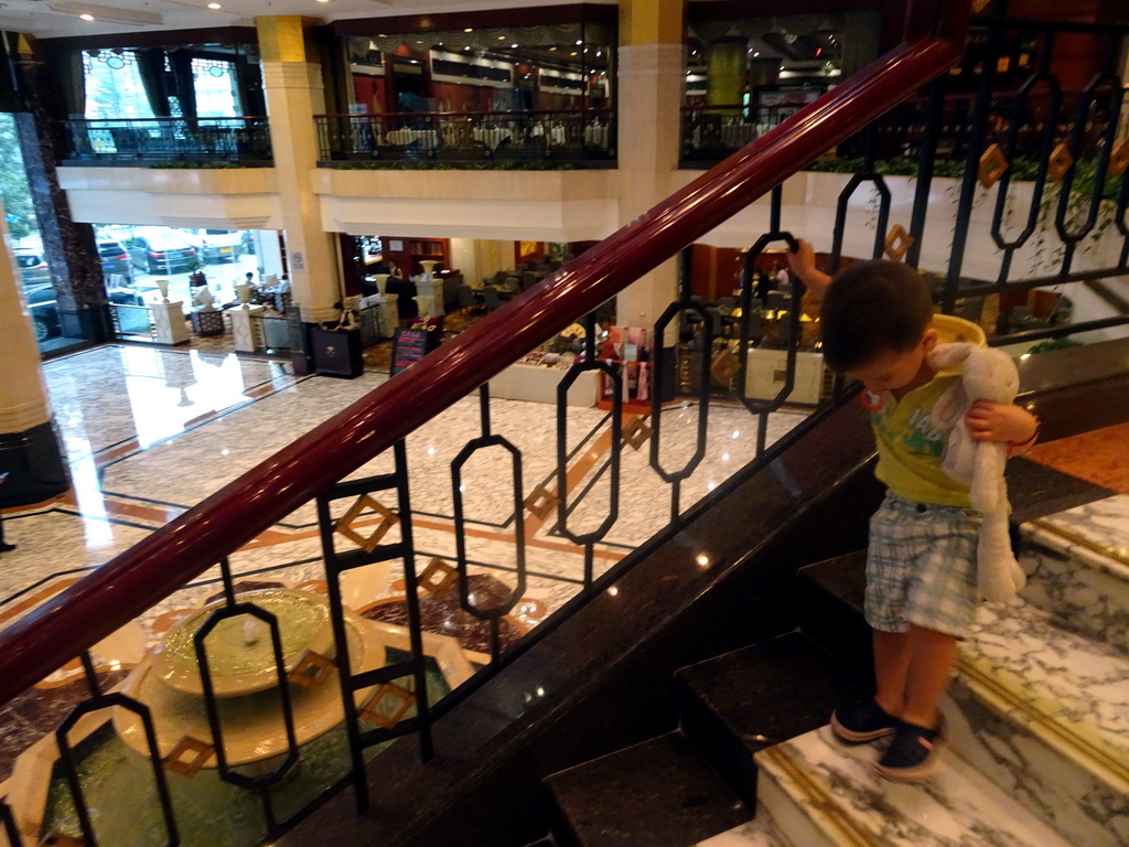 Max on the staircase in the lobby of the Beijing Prime Hotel Wanfujing