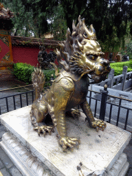 Golden Chinese Unicorn statue in front of the One Heavenly Gate at the Imperial Garden of the Forbidden City