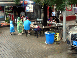 People drinking yoghurt at Zhishanmen Street