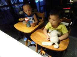 Max and his cousin in a restaurant at the Intime Lotte department store