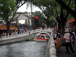 The Silver Ingot Bridge and a boat on Houhai Lake, viewed from the Houhai Nanyan street