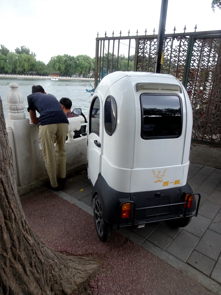 Rickshaw at the Houhai Nanyan street, with a view on Houhai Lake