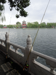 beijing_3_725 - 288 kb - 768x1024 - Fishing poles at the Houhai Nanyan street, with a view on Houhai Lake and the pavilion at the Houhai Beiyan street Fishing poles at the Houhai Nanyan street, with a view on Houhai Lake and the pavilion at the Houhai Beiyan street