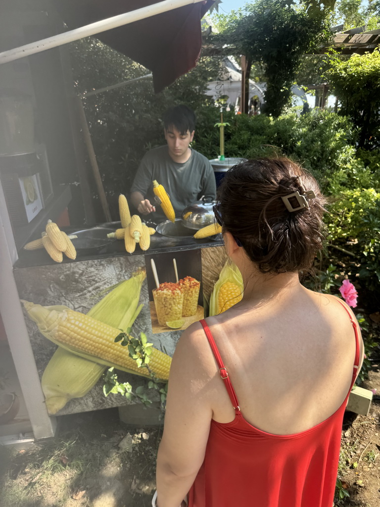 Miaomiao buying corn at the Adventure Land area of the Land of Legends theme park