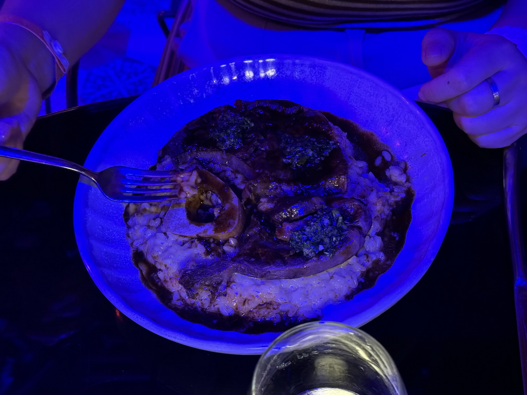 Miaomiao eating Ossobuco at the terrace of the Piazzetta Italiana restaurant at the Shopping Avenue area of the Land of Legends theme park, at sunset