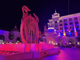 Piece of art in front of the Kingdom Hotel and the Chateau at the Shopping Avenue area of the Land of Legends theme park, by night