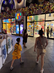 Miaomiao and Max in front of the Candy Candy store at the Shopping Avenue area of the Land of Legends theme park, by night