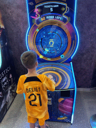 Max playing a game at the Arcade at the Candy Candy store at the Shopping Avenue area of the Land of Legends theme park