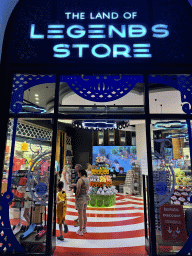 Miaomiao and Max at the entrance to the Land of Legends Store at the Chateau at the Shopping Avenue area of the Land of Legends theme park, by night