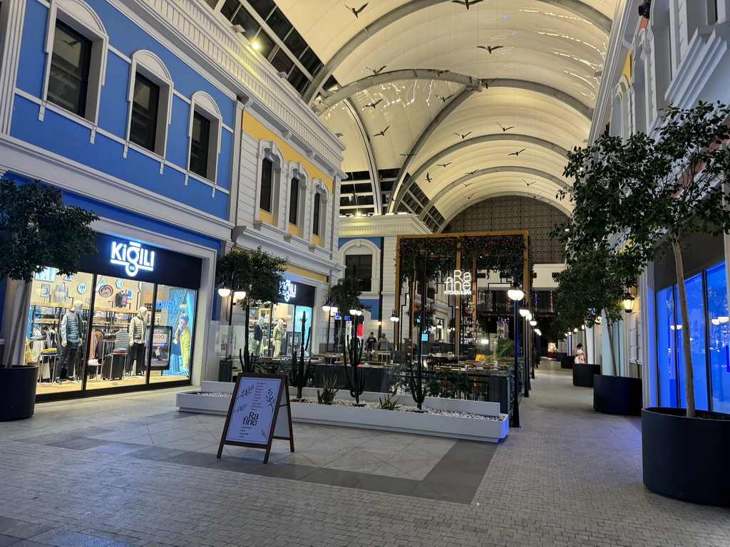 Shops and restaurants at the northeast side of the Shopping Avenue area of the Land of Legends theme park, by night