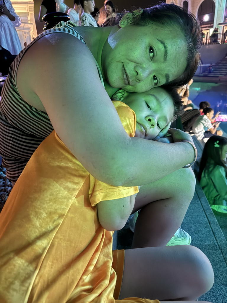 Miaomiao and Max in front of the Chateau at the Shopping Avenue area of the Land of Legends theme park, just before the Musical Boat Parade, by night