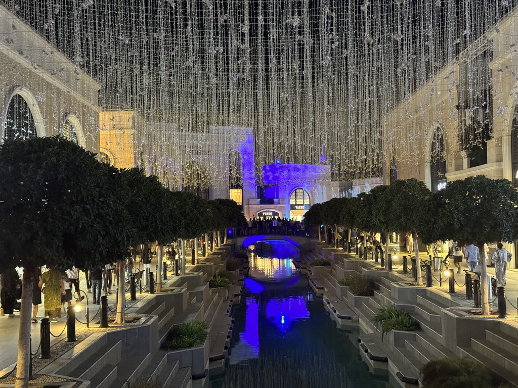 Bridge over the canal at the Shopping Avenue area of the Land of Legends theme park, during the Musical Boat Parade, by night