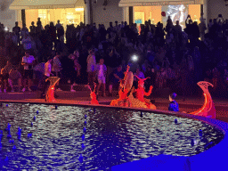 Boat with actors behind of the Chimera Fountain at the Shopping Avenue area of the Land of Legends theme park, during the Musical Boat Parade, by night