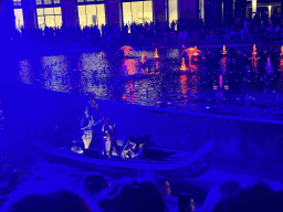 Boat with actors in front of the Chimera Fountain at the Shopping Avenue area of the Land of Legends theme park, during the Musical Boat Parade, by night