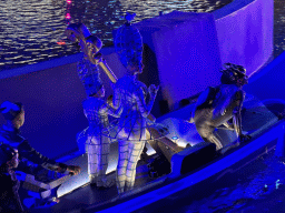 Boat with actors in front of the Chimera Fountain at the Shopping Avenue area of the Land of Legends theme park, during the Musical Boat Parade, by night