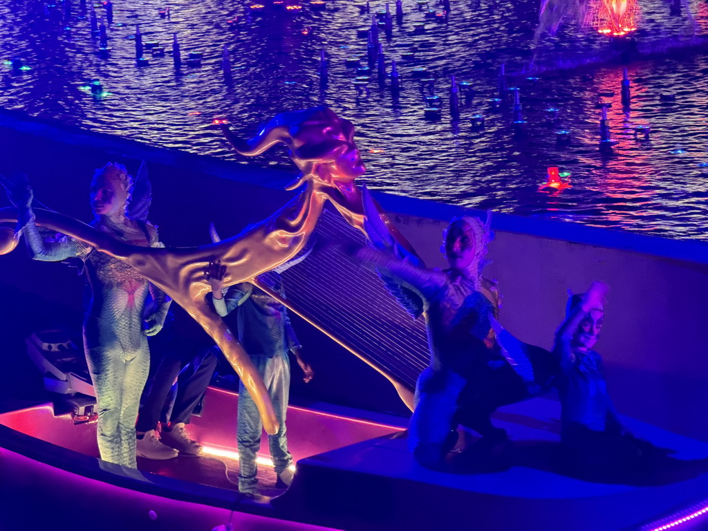 Boat with actors in front of the Chimera Fountain at the Shopping Avenue area of the Land of Legends theme park, during the Musical Boat Parade, by night