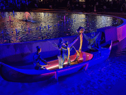 Boat with actors in front of the Chimera Fountain at the Shopping Avenue area of the Land of Legends theme park, during the Musical Boat Parade, by night