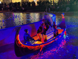 Boat with actors in front of the Chimera Fountain at the Shopping Avenue area of the Land of Legends theme park, during the Musical Boat Parade, by night