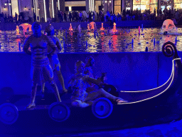 Boat with actors in front of the Chimera Fountain at the Shopping Avenue area of the Land of Legends theme park, during the Musical Boat Parade, by night