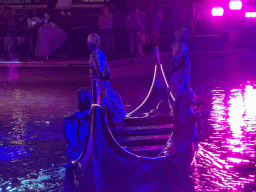 Boat with actors at the canal at the Shopping Avenue area of the Land of Legends theme park, during the Musical Boat Parade, by night