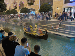 Boat with actors at the canal at the Shopping Avenue area of the Land of Legends theme park, during the Musical Boat Parade, by night