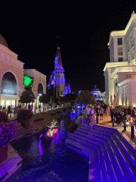 Boats with actors at the canal and the Chateau at the Shopping Avenue area of the Land of Legends theme park, during the Musical Boat Parade, by night