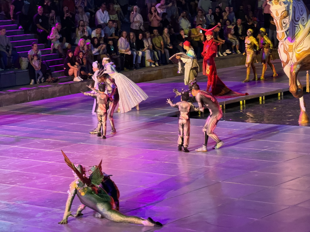 Actors and horse statue in front of the Chateau at the Shopping Avenue area of the Land of Legends theme park, during the Musical Boat Parade, by night