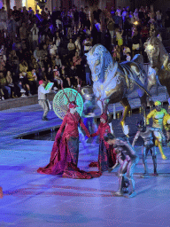 Actors and horse statues in front of the Chateau at the Shopping Avenue area of the Land of Legends theme park, during the Musical Boat Parade, by night