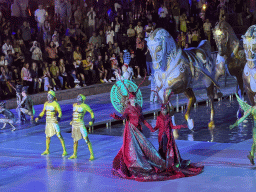 Actors and horse statues in front of the Chateau at the Shopping Avenue area of the Land of Legends theme park, during the Musical Boat Parade, by night