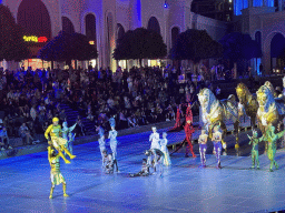 Actors and horse statues in front of the Chateau at the Shopping Avenue area of the Land of Legends theme park, during the Musical Boat Parade, by night