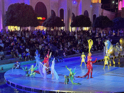 Actors and horse statues in front of the Chateau at the Shopping Avenue area of the Land of Legends theme park, during the Musical Boat Parade, by night