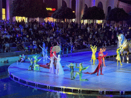 Actors and horse statue in front of the Chateau at the Shopping Avenue area of the Land of Legends theme park, during the Musical Boat Parade, by night