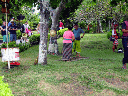 Tourists with a snake in the gardens of the Pura Tanah Lot temple complex