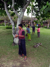 Tourists with a snake in the gardens of the Pura Tanah Lot temple complex