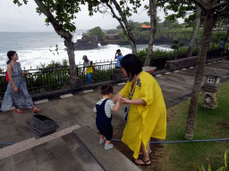 Miaomiao and Max in the gardens of the Pura Tanah Lot temple complex, with a view on the Pura Batu Bolong temple