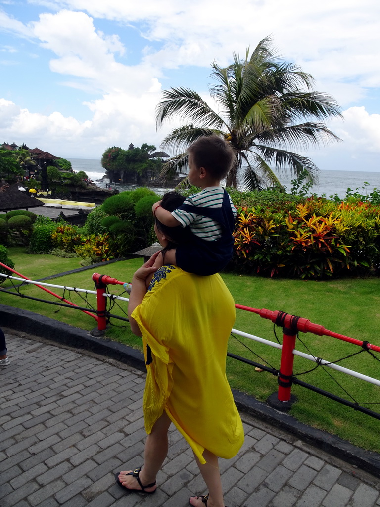 Miaomiao and Max in the gardens of the Pura Tanah Lot temple complex, with a view on the Pura Tanah Lot temple