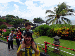 Miaomiao and Max in the gardens of the Pura Tanah Lot temple complex, with a view on the Pura Tanah Lot temple