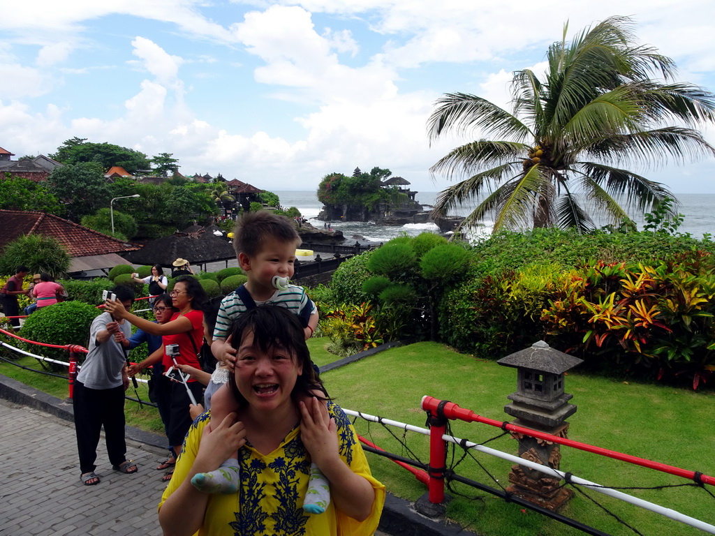 Miaomiao and Max in the gardens of the Pura Tanah Lot temple complex, with a view on the Pura Tanah Lot temple