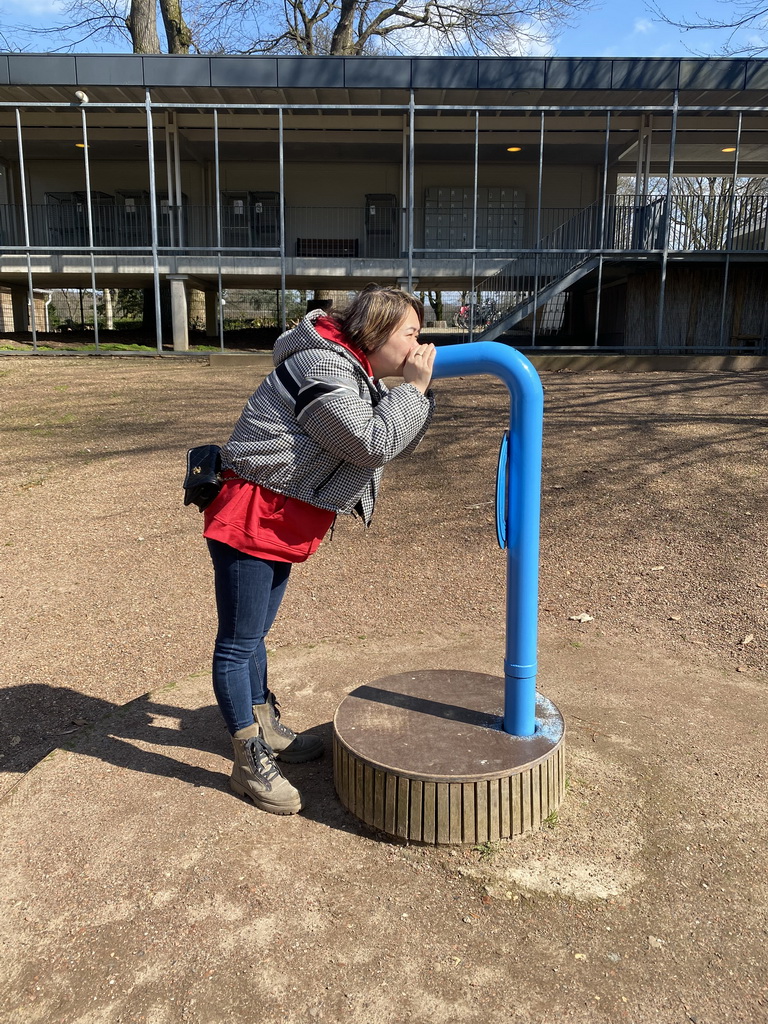 Miaomiao with a speaking tube at the main square of the Museumpark of the Africa Museum