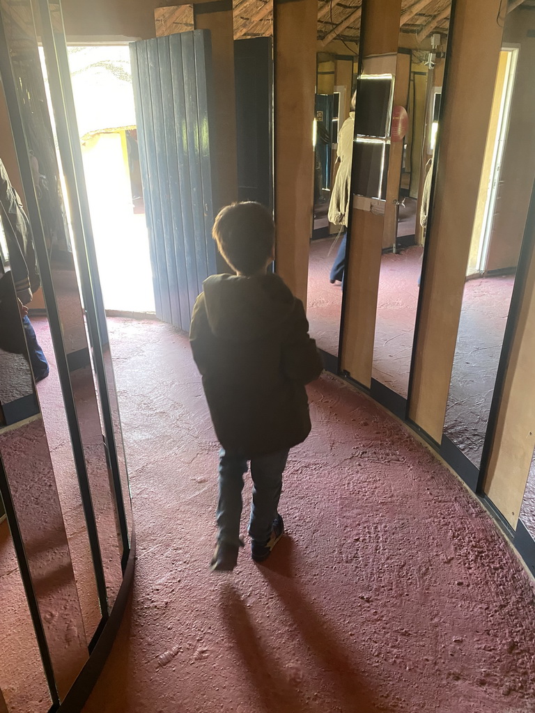 Max with mirrors in a house at the Lesotho village at the Museumpark of the Africa Museum