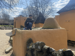 Max on top of a small house at the Mali village at the Museumpark of the Africa Museum