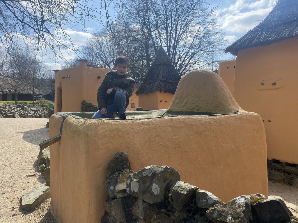Max on top of a small house at the Mali village at the Museumpark of the Africa Museum