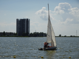 Boat at the Binnenschelde lake and the Mayflower Holding building, viewed from the beach