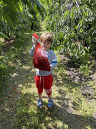 Max`s friend with a bag with cherries at the FrankenFruit fruit farm